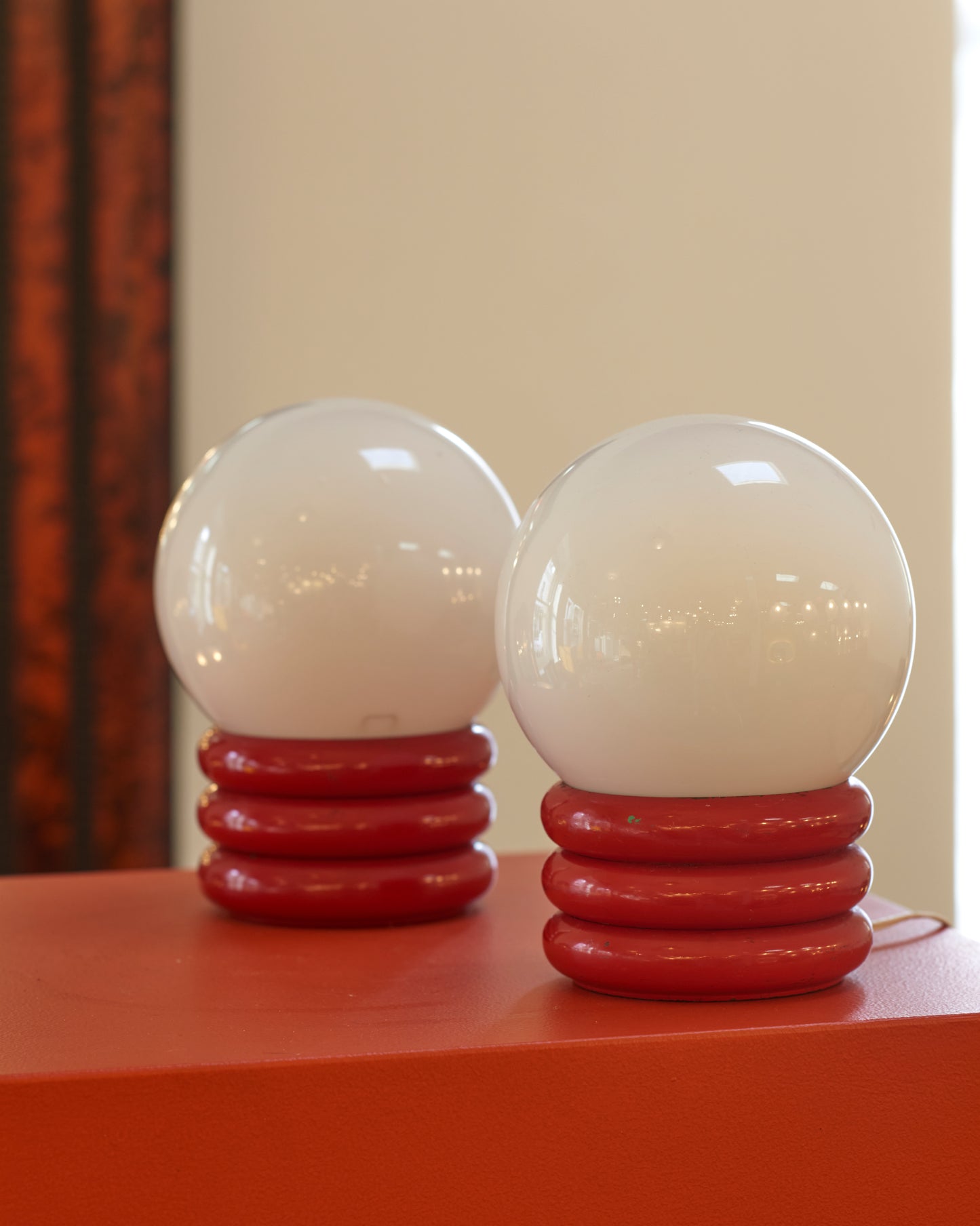 PAIR OF SMALL RED ROLL ORB LAMPS