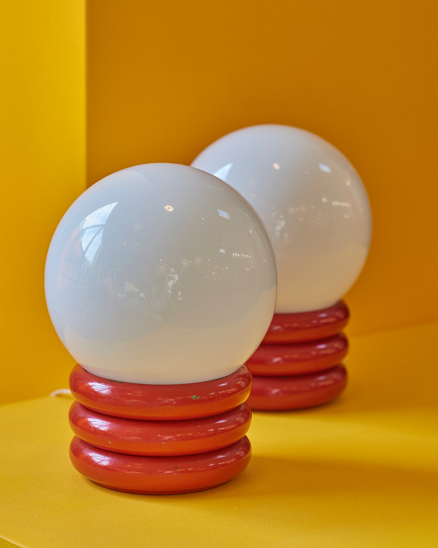 PAIR OF SMALL RED ROLL ORB LAMPS