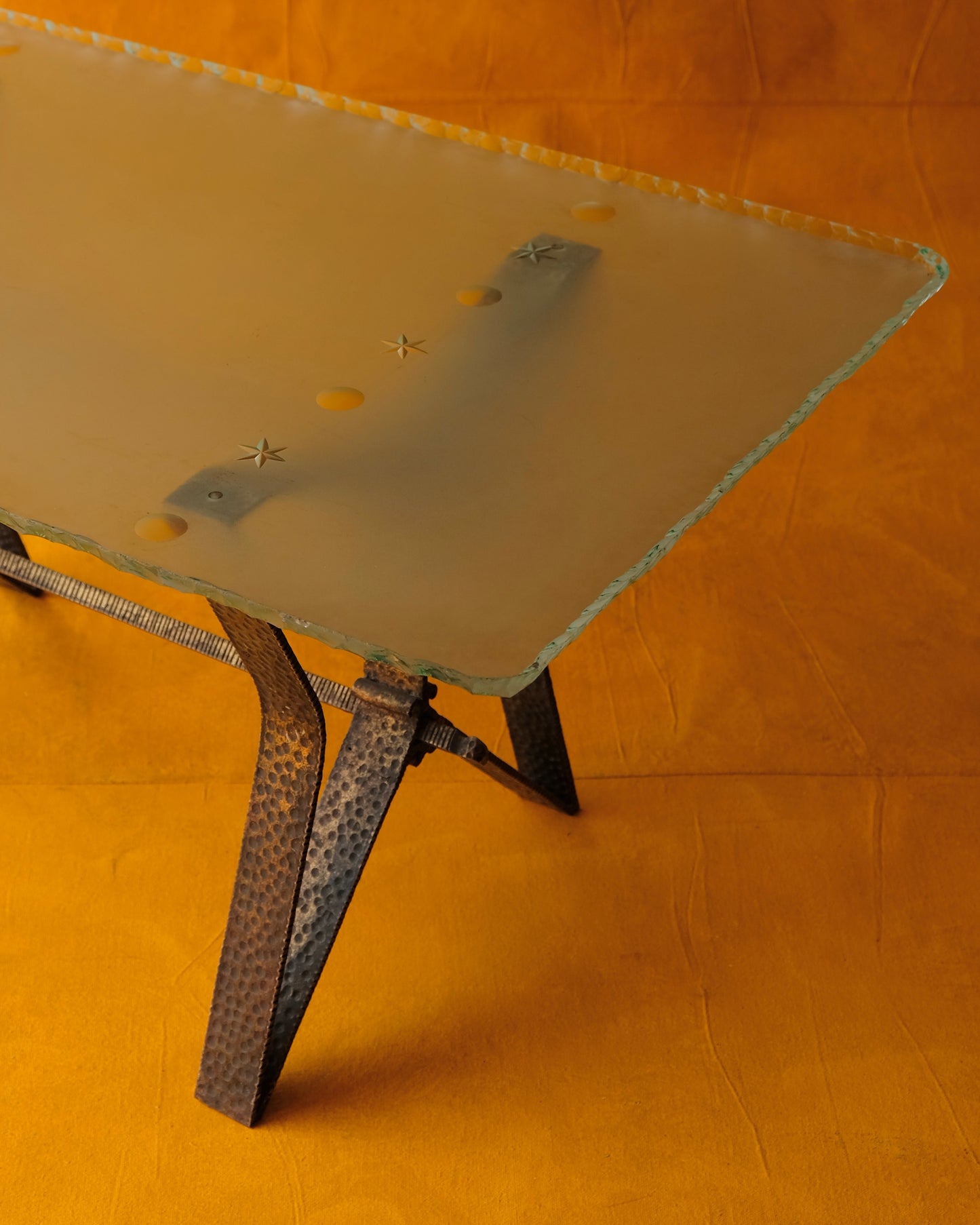 BRASS BASE COFFEE TABLE w. CARVED EDGED GLASS