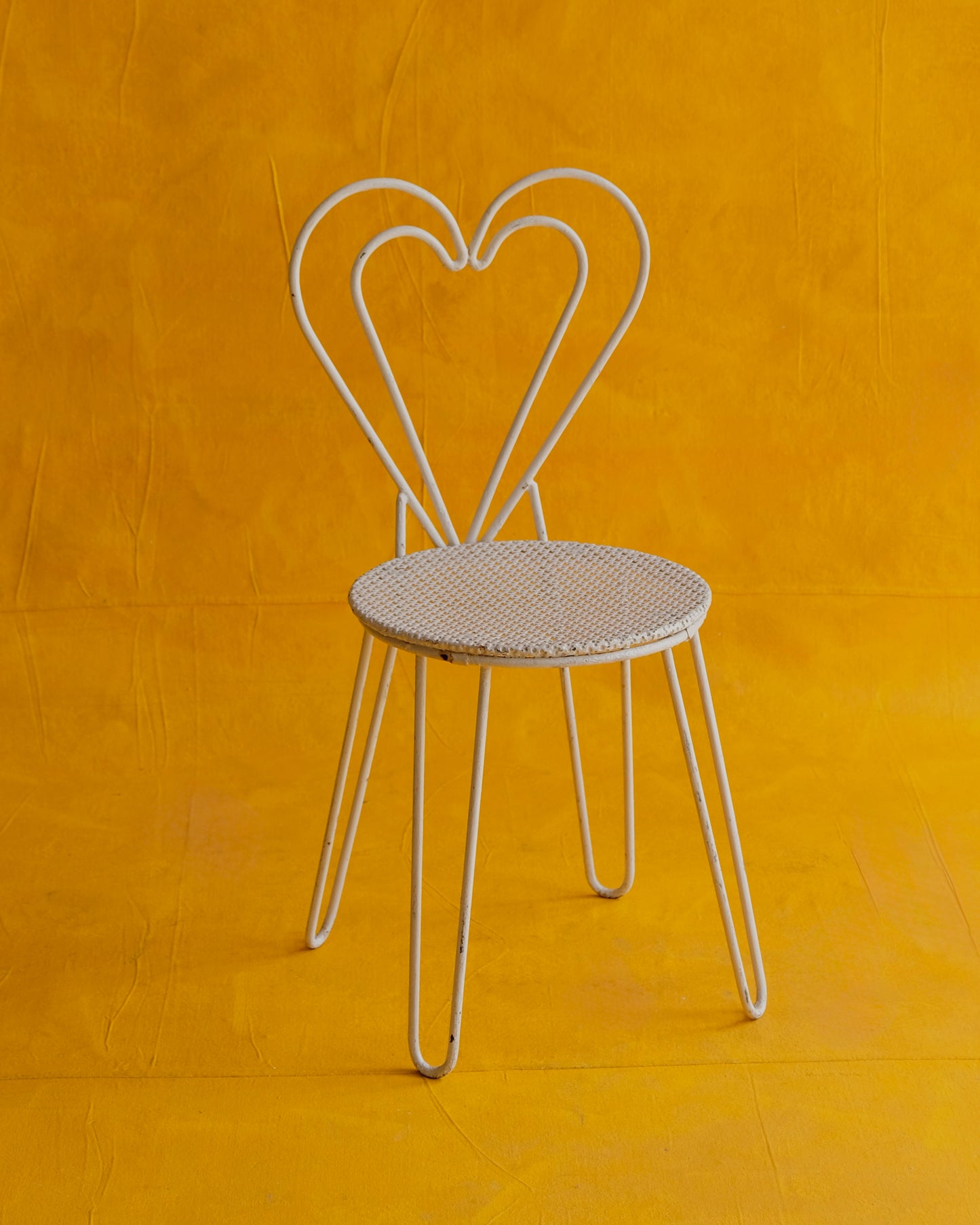 PAIR OF WHITE METAL HEART CHAIRS