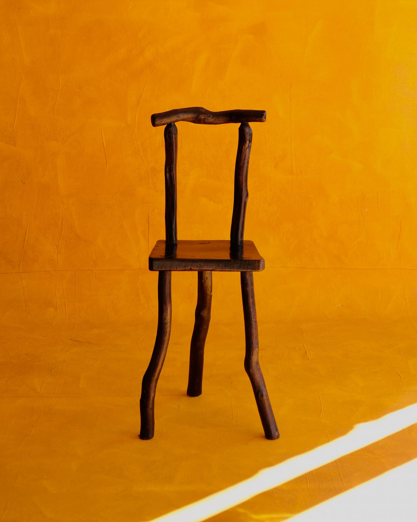 HAND CARVED EBONIZED PRIMITIVE TALL CHAIR