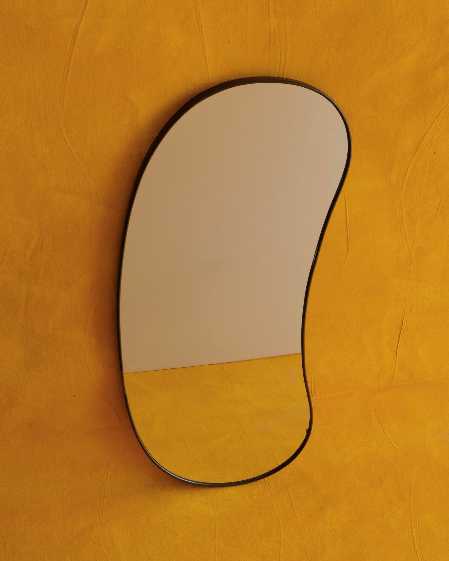MODERNIST CURVED BRASS MIRROR