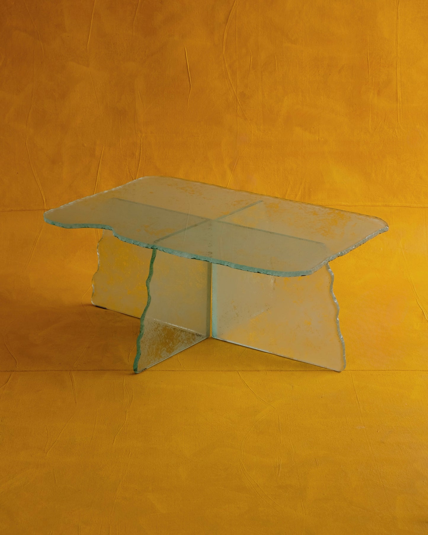 HAND CARVED GLASS CROSS BASED COFFEE TABLE