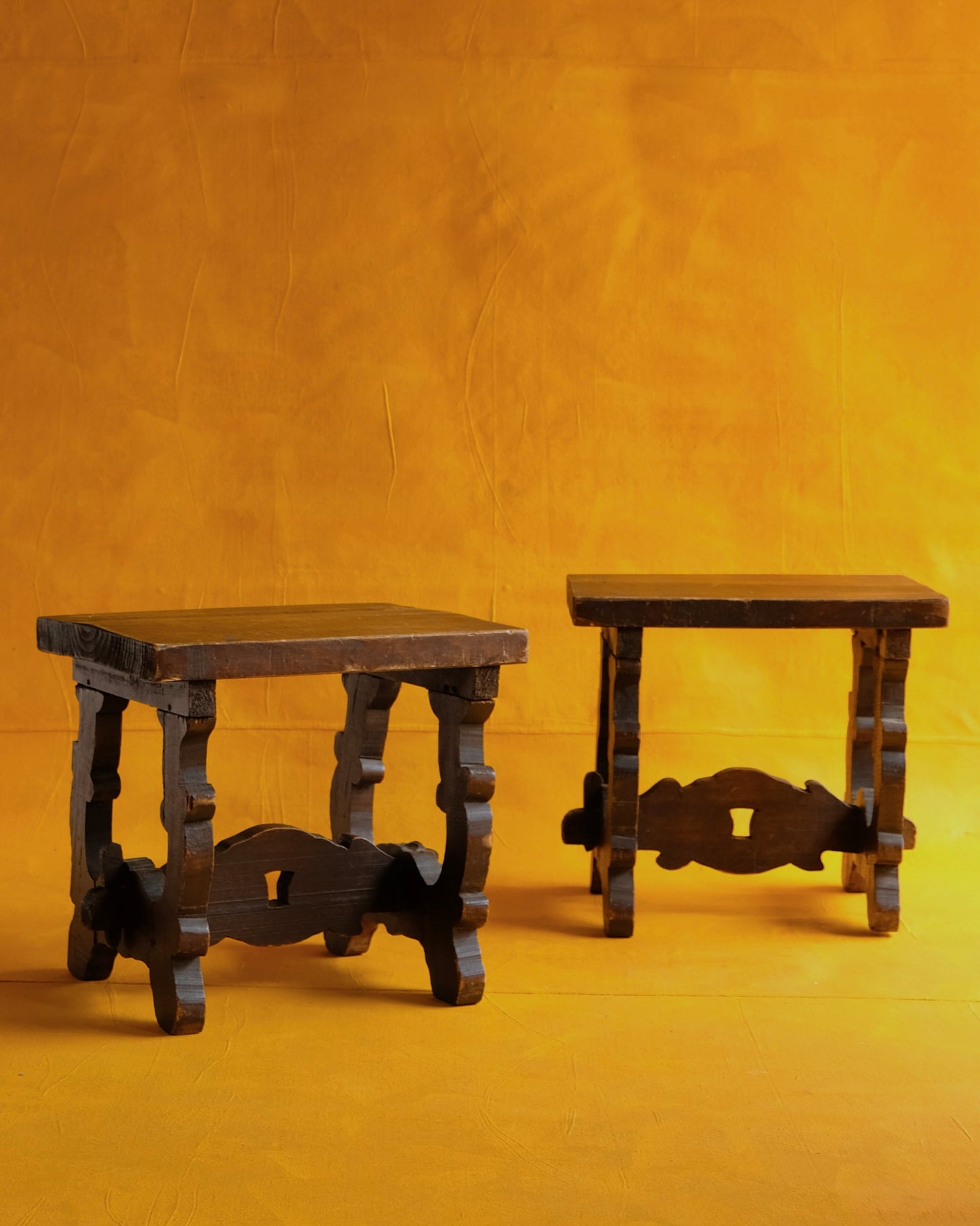 PAIR OF INTERLOCKING SPANISH WALNUT SIDE TABLES