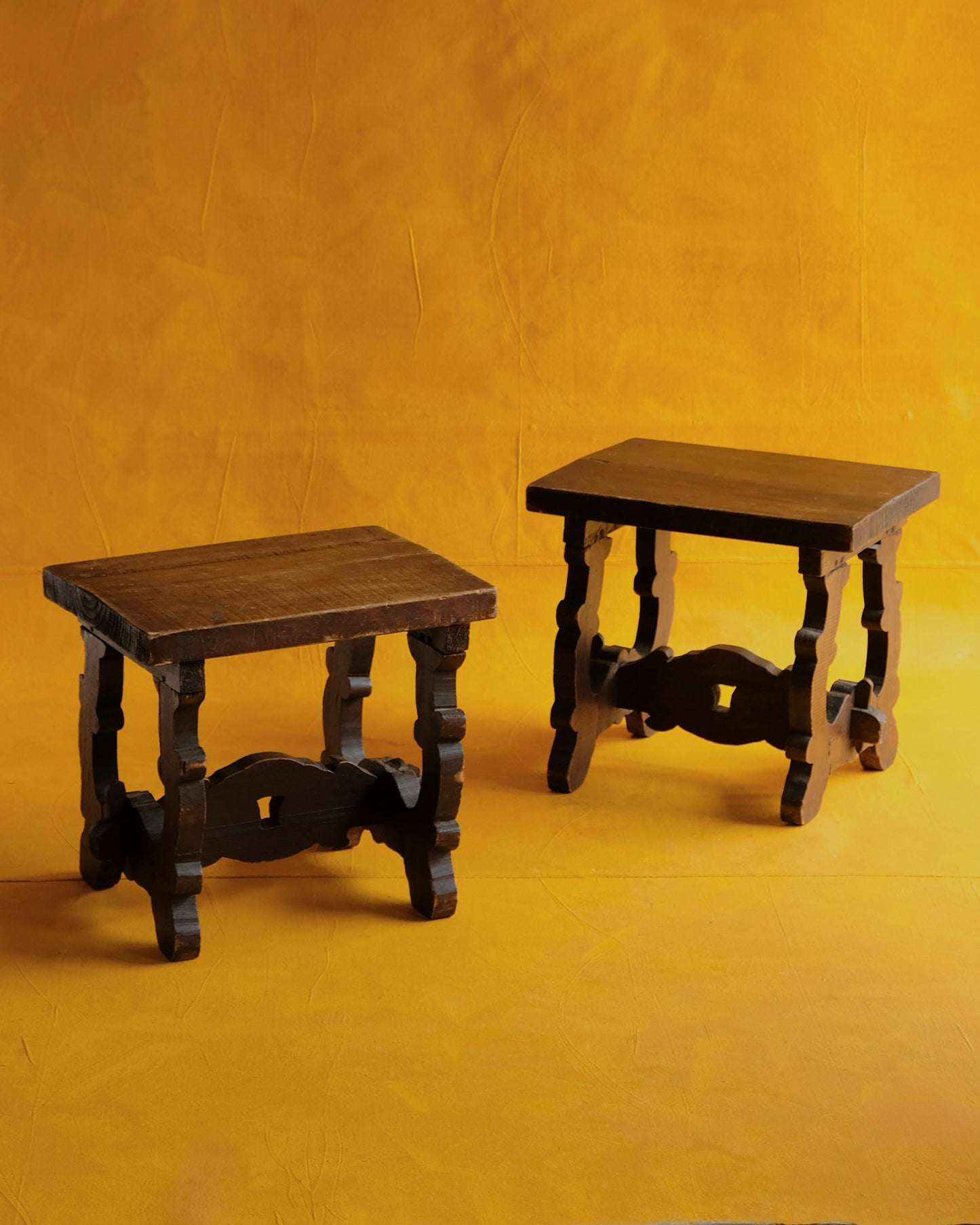 PAIR OF INTERLOCKING SPANISH WALNUT SIDE TABLES