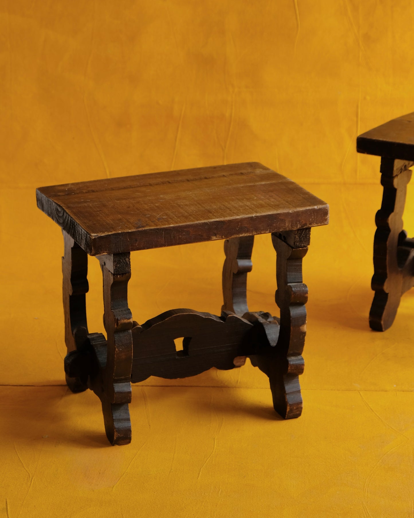 PAIR OF INTERLOCKING SPANISH WALNUT SIDE TABLES