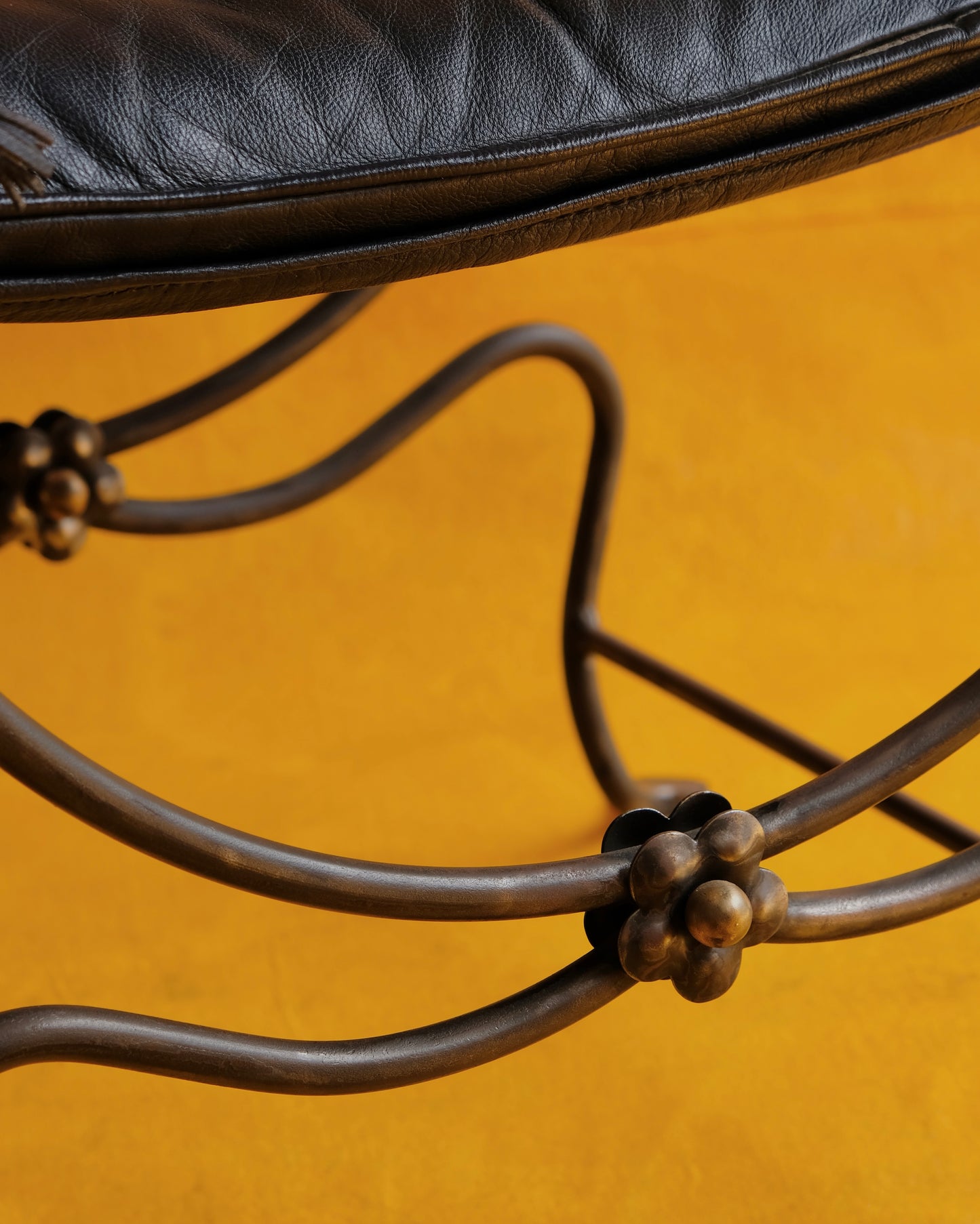 PAIR OF IRON CURULE CHAIRS w. FLORAL DETAIL