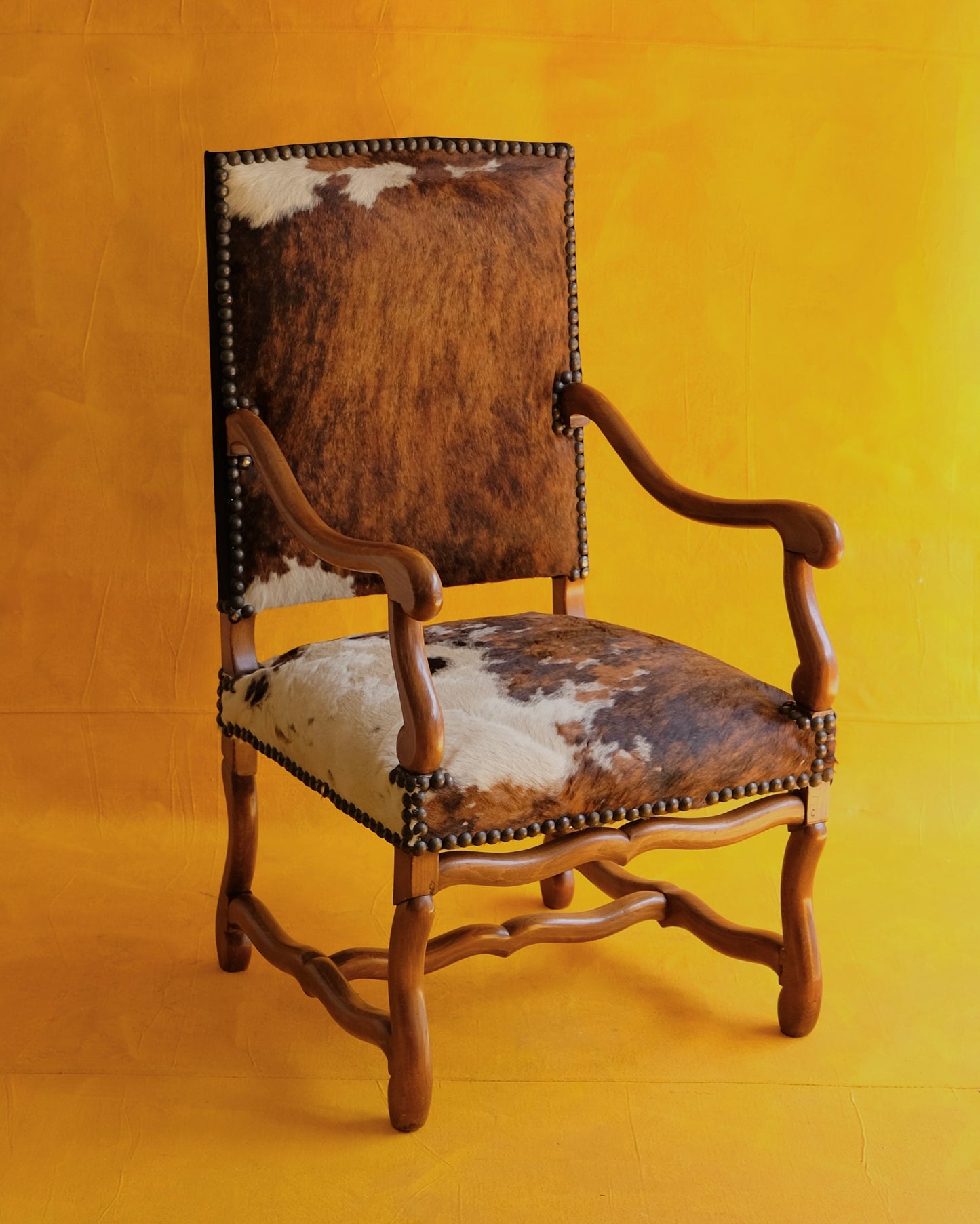 PAIR OF SPANISH WALNUT & COW HIDE ARMCHAIRS