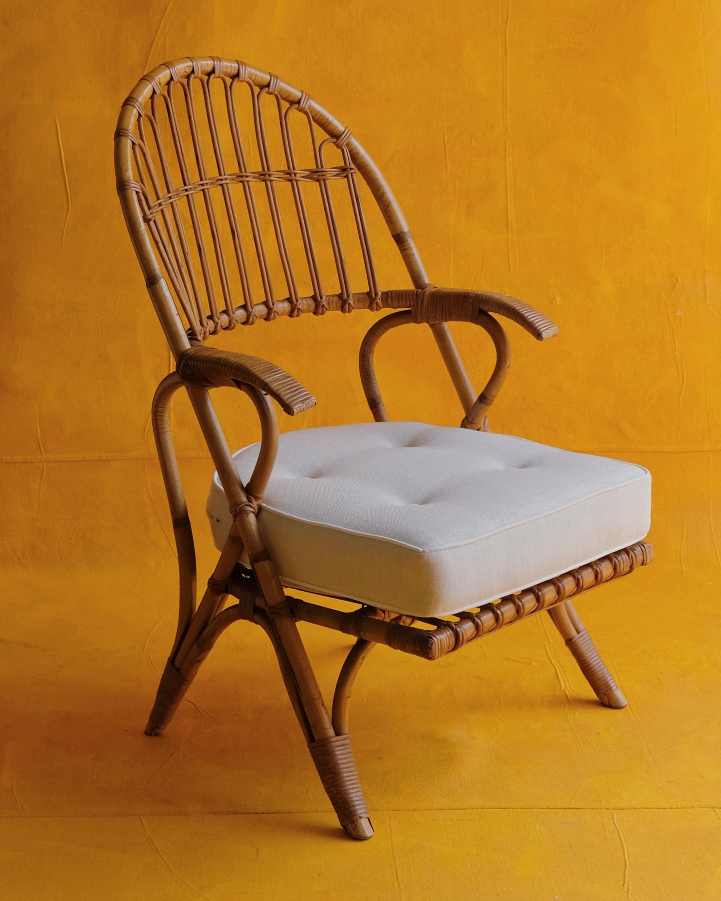 PAIR OF CANE ARM CHAIRS w. CONTRAST CUSHIONS