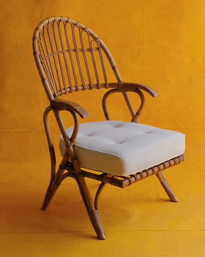 PAIR OF CANE ARM CHAIRS w. CONTRAST CUSHIONS