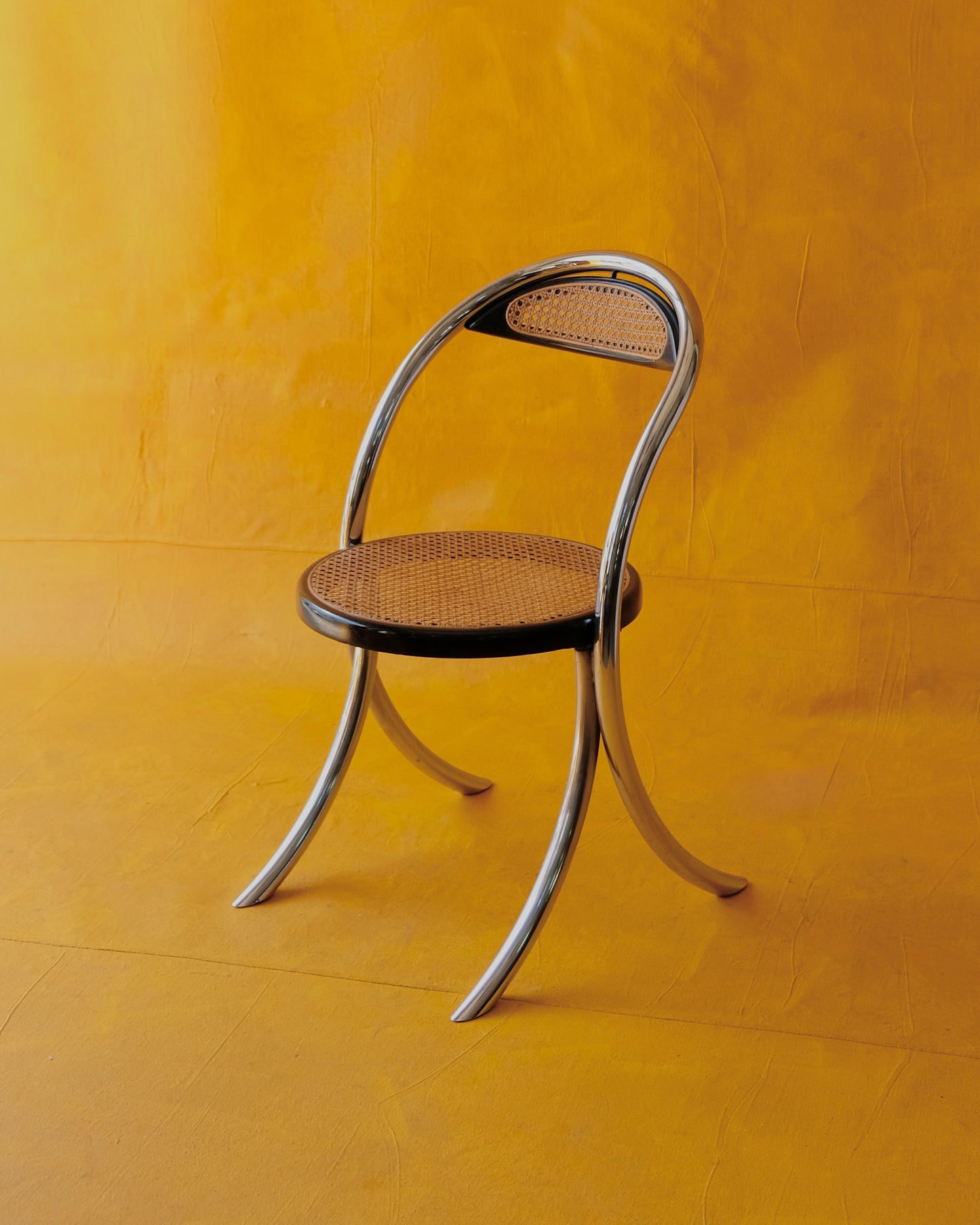 SET OF EIGHT CURVED CHROME & RATTAN CHAIRS