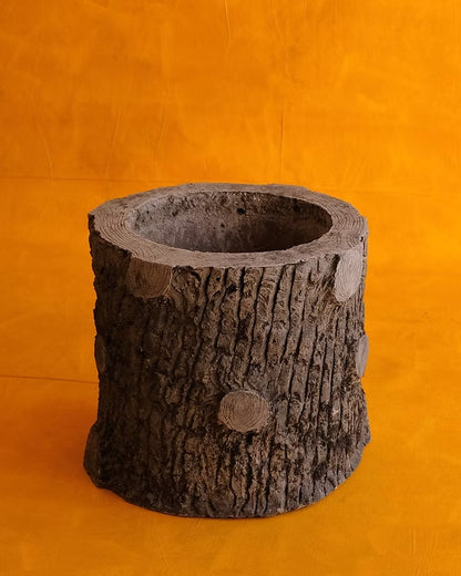 SET OF SIX SCULPTURAL CEMENT TRUNK PLANTERS