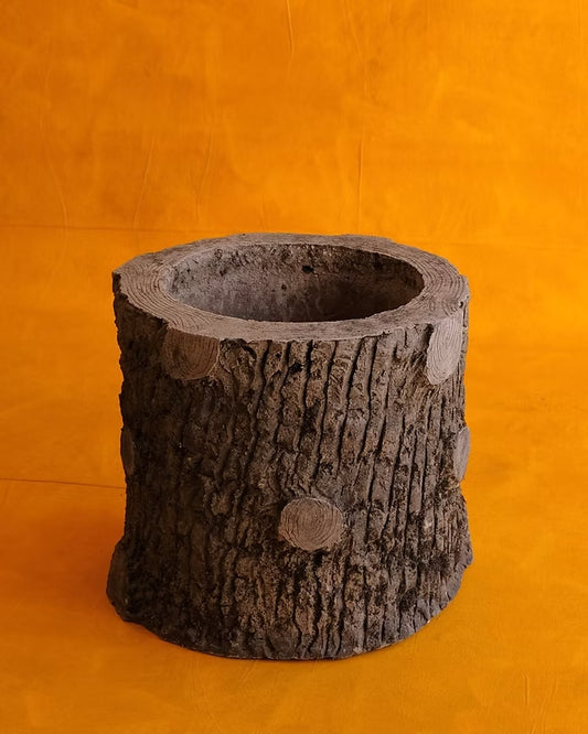 SET OF SIX SCULPTURAL CEMENT TRUNK PLANTERS